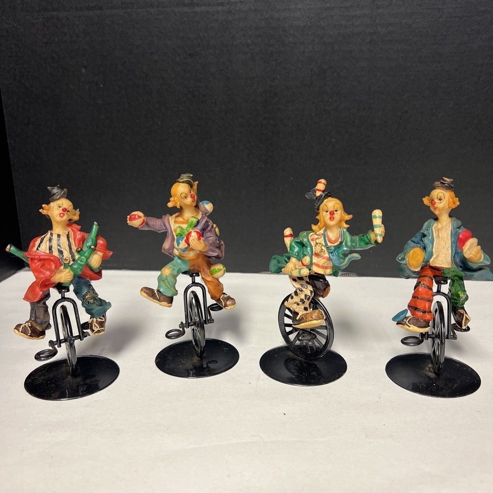 Set Of 4 k's collection clown figurines riding unicycles